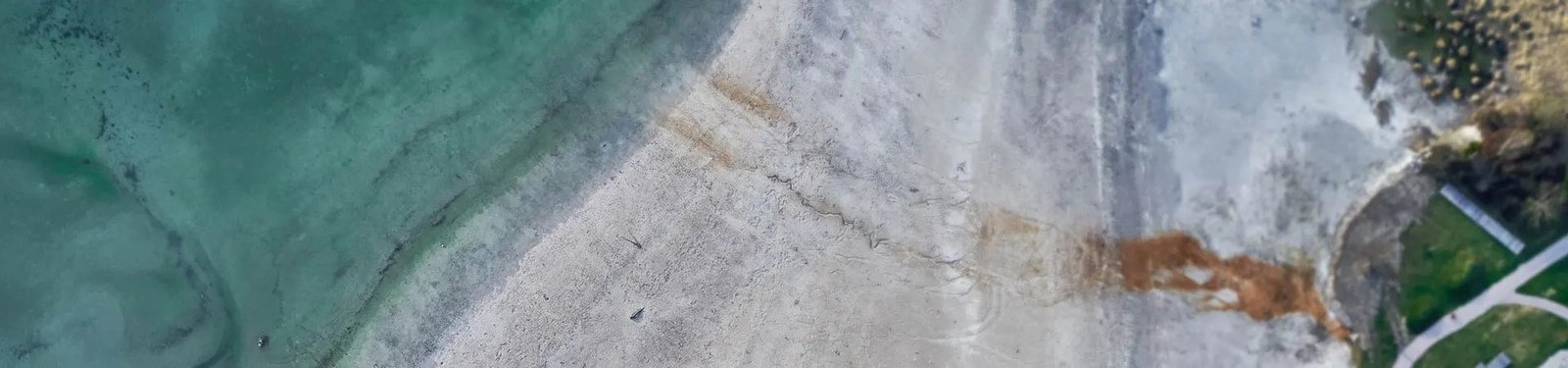 Aerial view of water and a quarry shoreline
